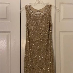 Formal nude and sparkly dress.